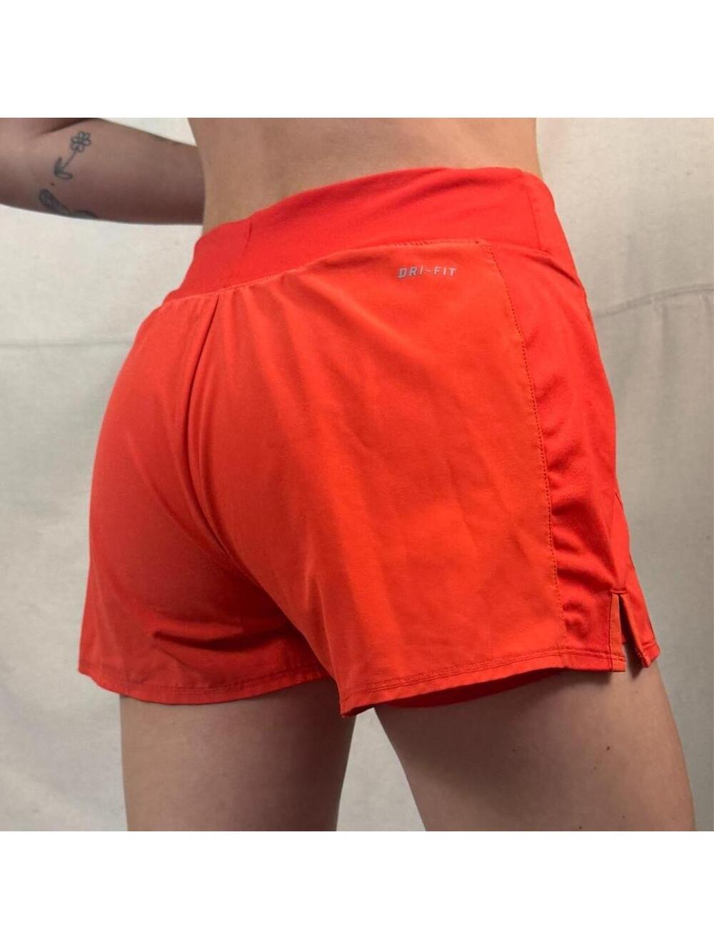 Nike Dri-FIT running shorts in a vibrant coral-red colorway